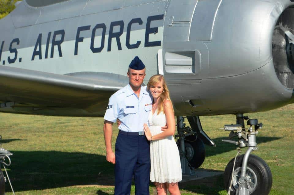 U.S. Air Force member with partner in front of military aircraft, symbolizing Merit Maids' support for military families in Salt Lake City